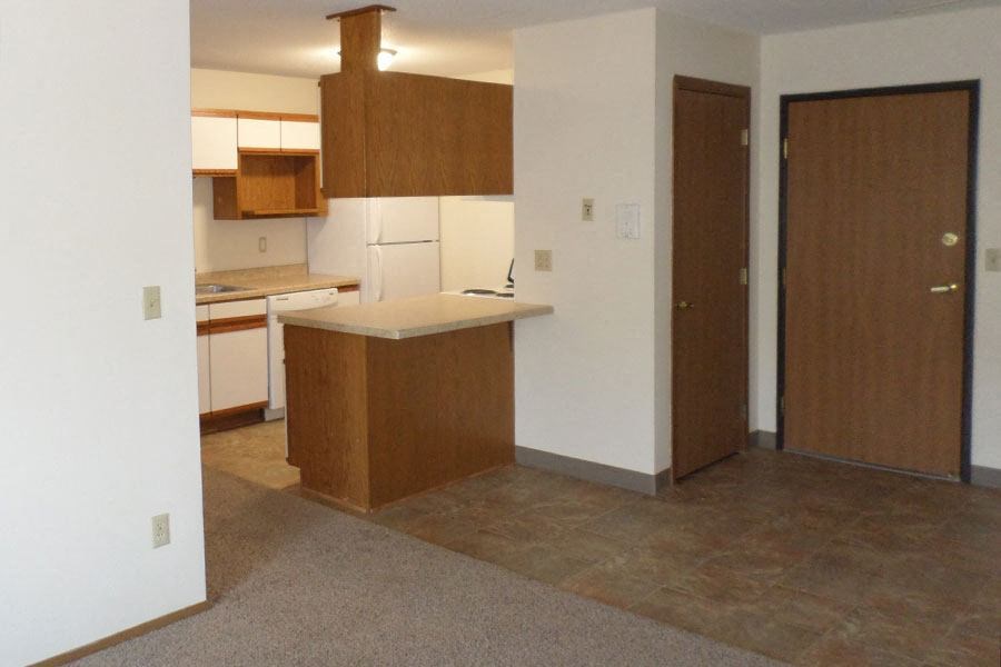 an empty kitchen with an island in the middle