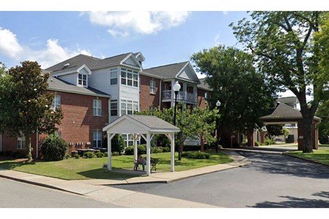 a house with a white gazebo on a street