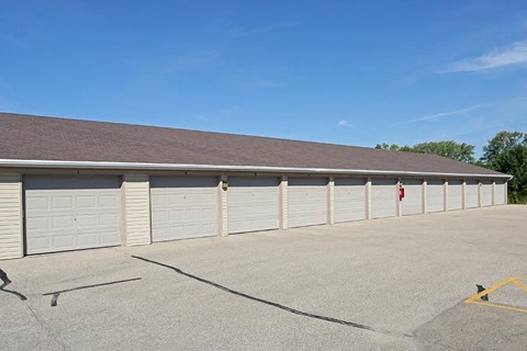 a parking lot with a row of garages