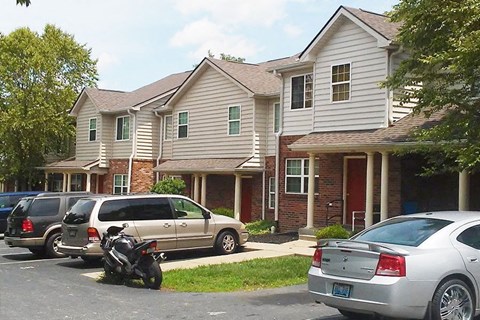 a motorcycle parked in a parking lot in front of houses