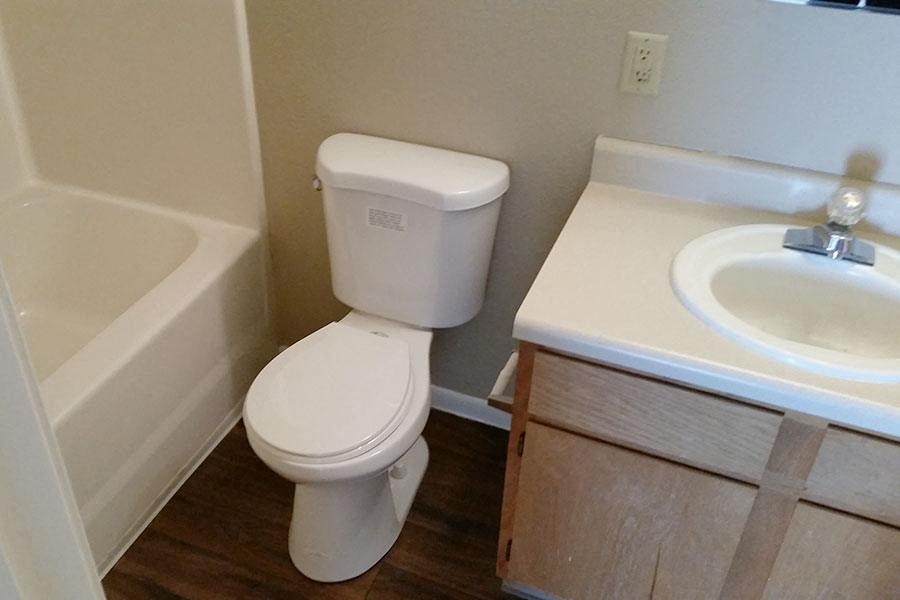 a bathroom with a toilet and a sink and a bath tub