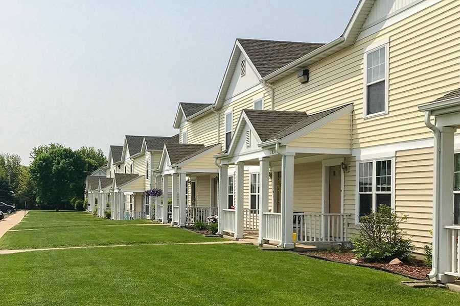 a row of houses with a green lawn