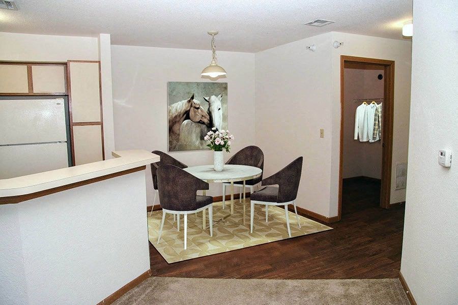 a dining room with a table and chairs