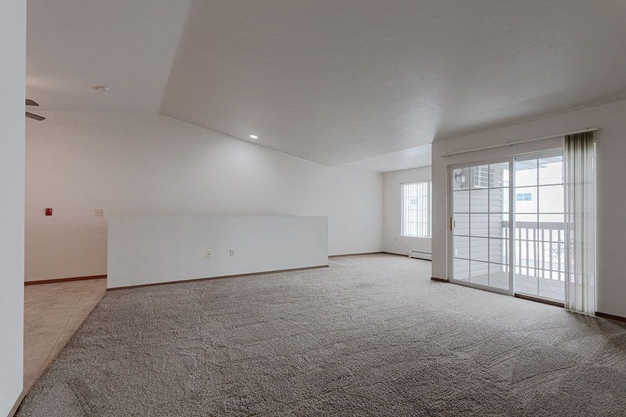 an empty living room with a large glass door