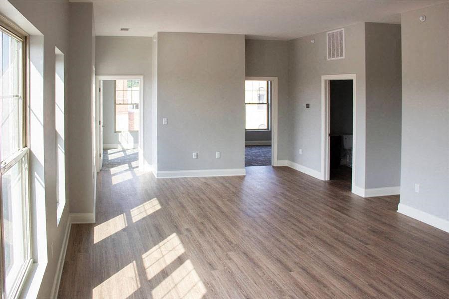 an empty living room with a hard wood floor