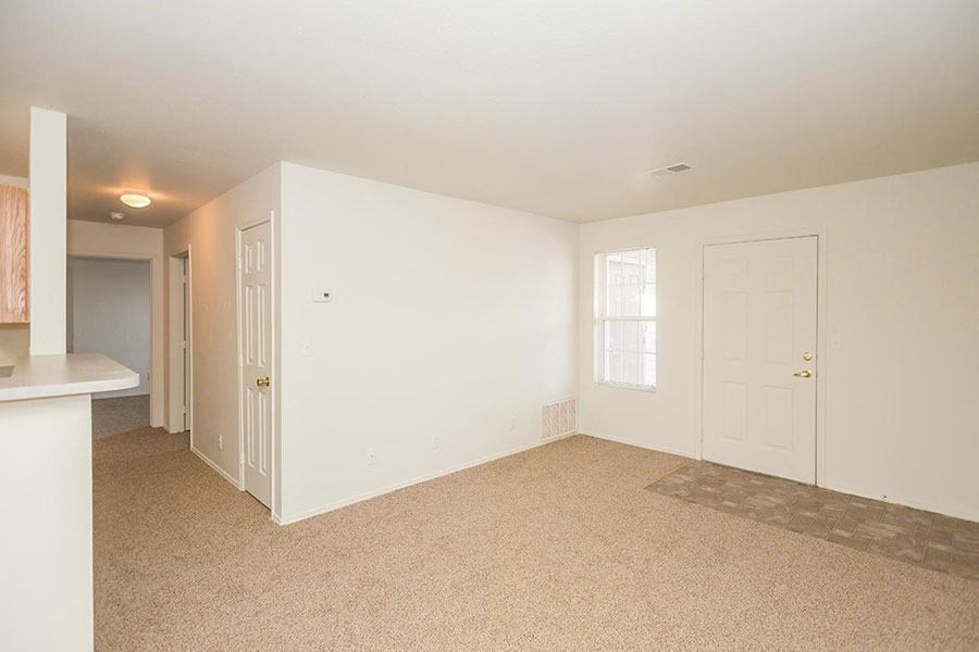 A room with a carpeted floor and white walls.