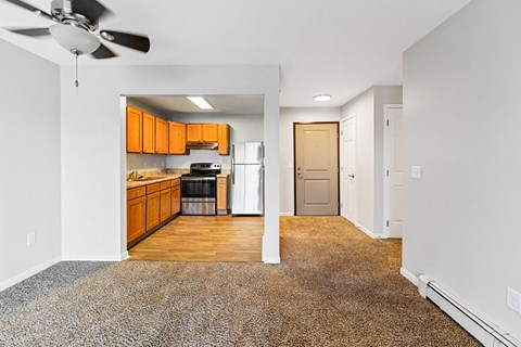 A kitchen with orange cabinets and a fan.