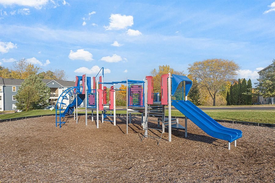 a childrens playground with slides in a park