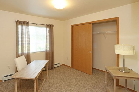 a dining room with a table and a closet
