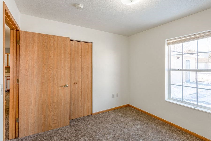 an empty room with a door and a window