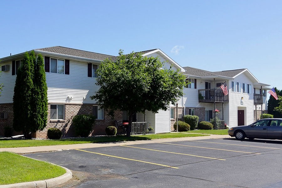a parking lot in front of an apartment building
