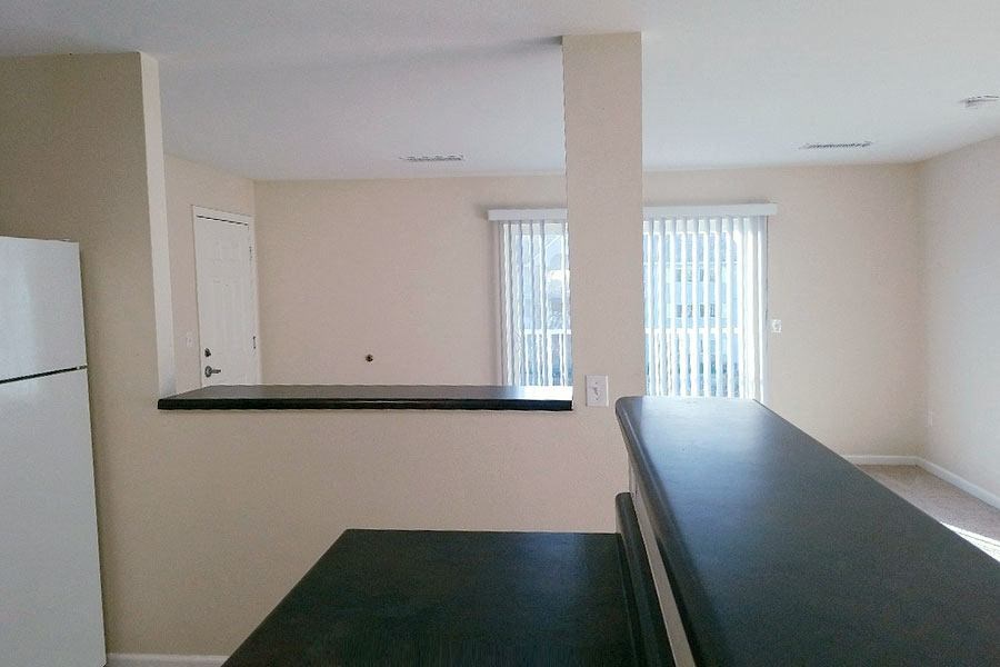 an empty kitchen with a counter and a window