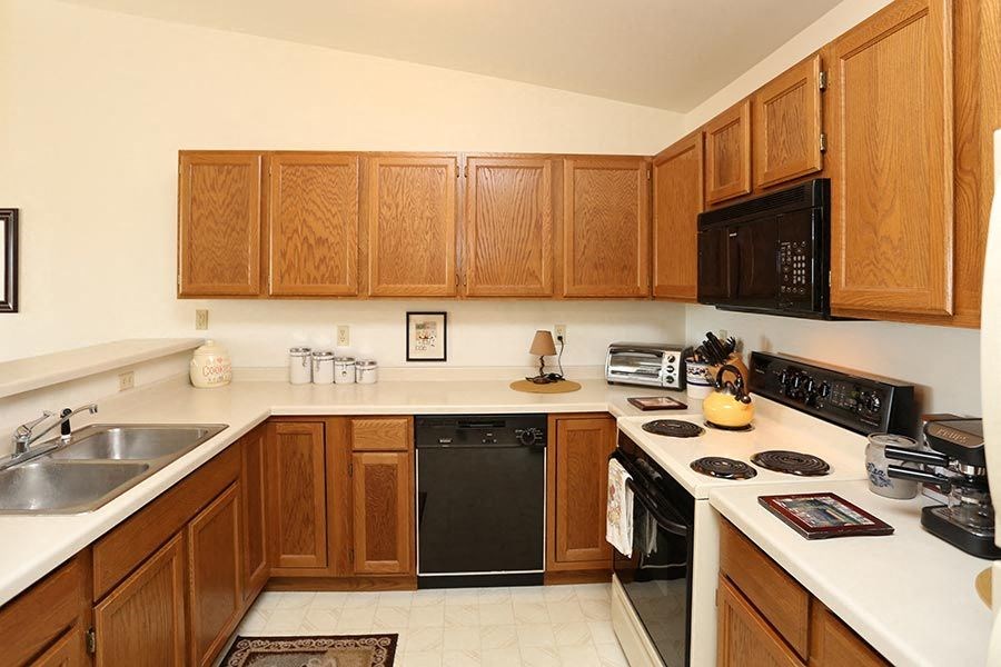 a kitchen with a stove top oven and a sink