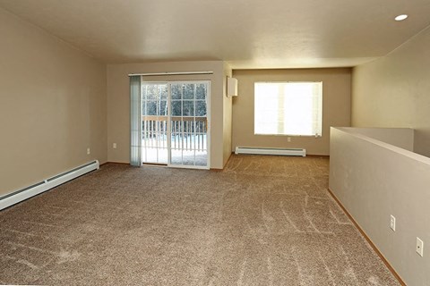 an empty living room with a sliding glass door
