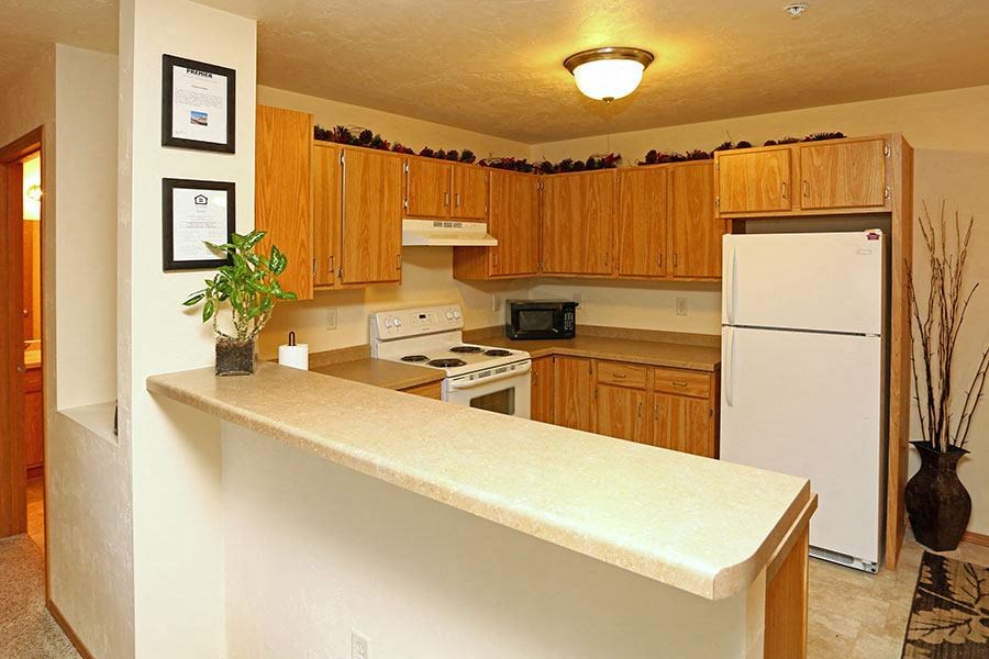 a kitchen with a counter and a refrigerator