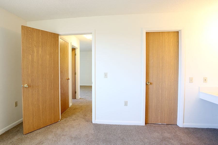 an empty room with three doors in it