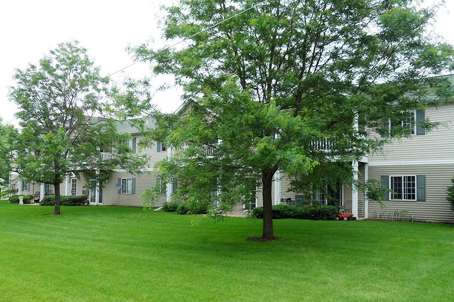 a large lawn in front of a white house