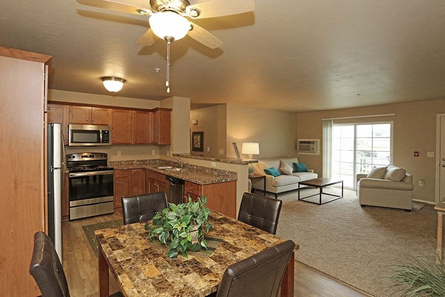 a kitchen and living room with a table