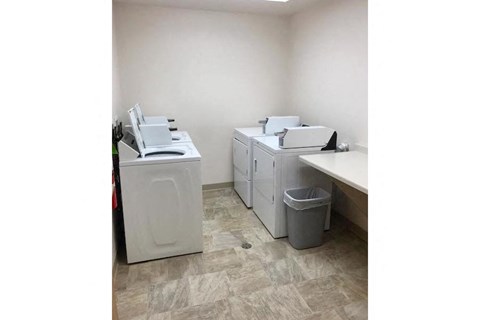 two washing machines and a counter in a room