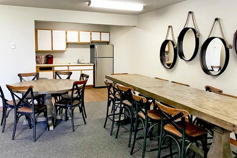 a dining room with a wooden table and chairs