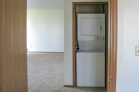 a white washer and dryer in an empty room