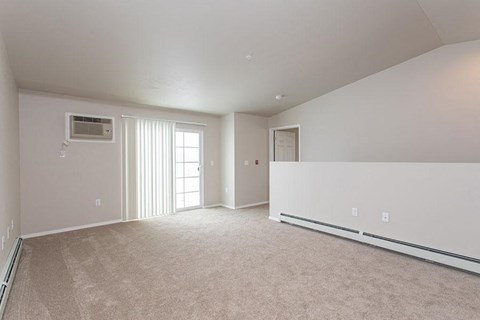 A spacious room with a window and a door.