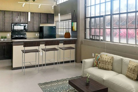 a living room with a kitchen and a couch