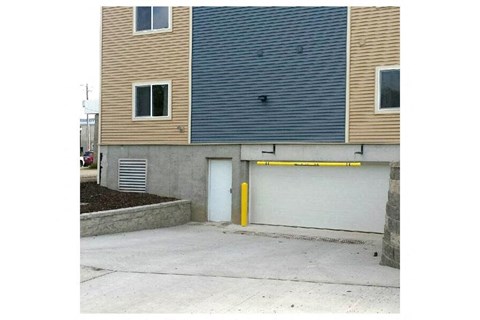 a house with a garage door and a building