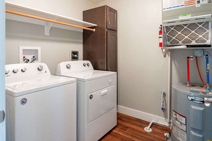 A small laundry room with a washer and dryer.