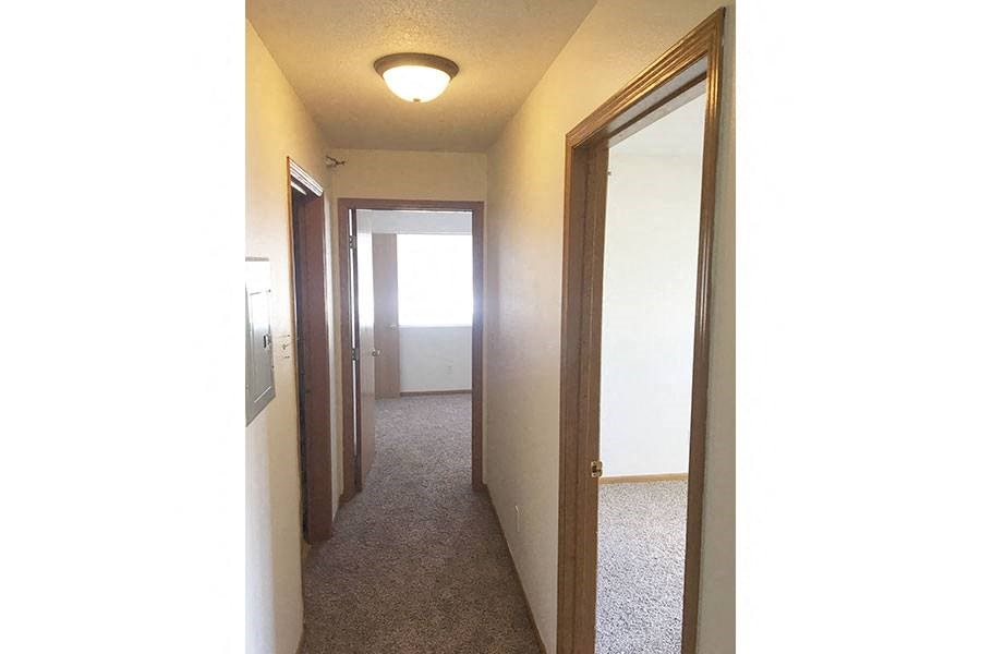a hallway with a mirror and a closet