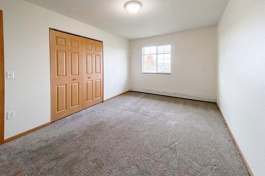 an empty room with a door and a window