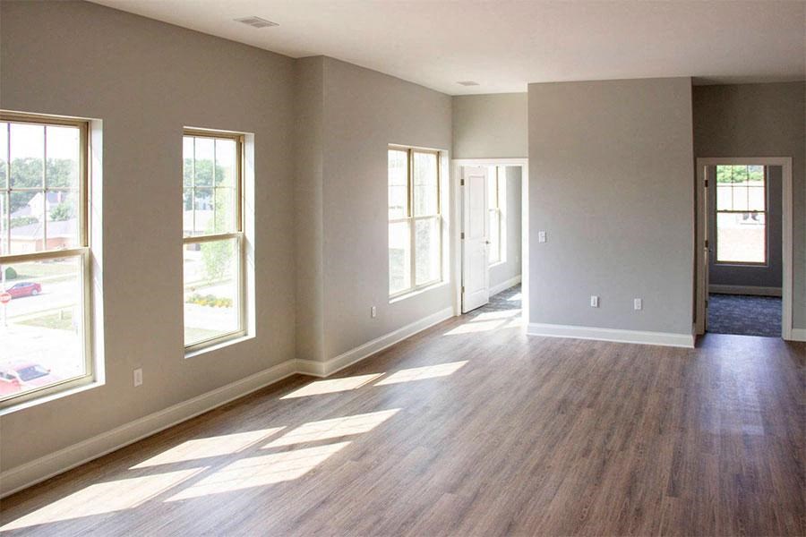 an empty living room with a hard wood floor