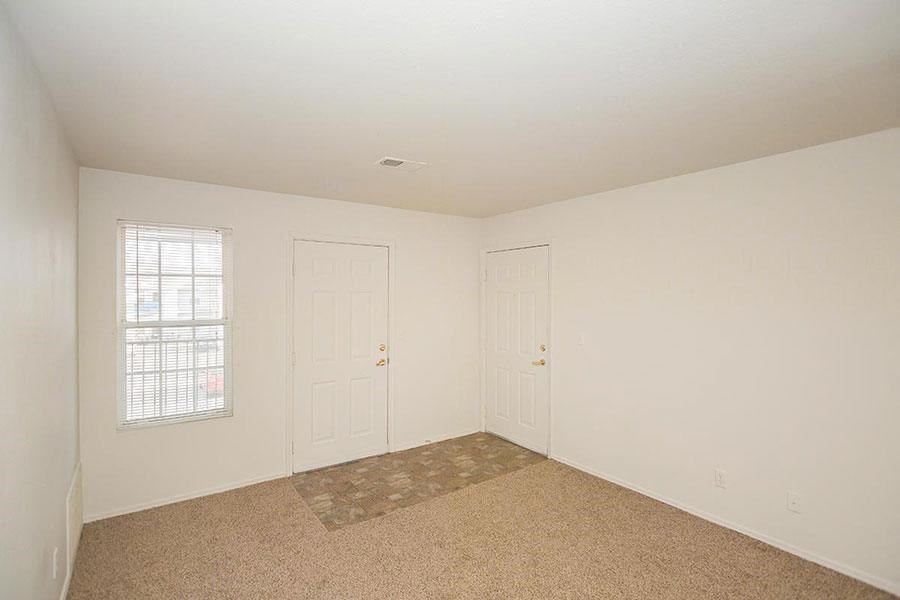 A room with two doors and a window.