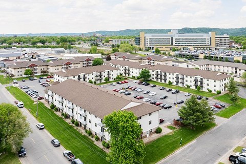 A large white building with a parking lot in front.