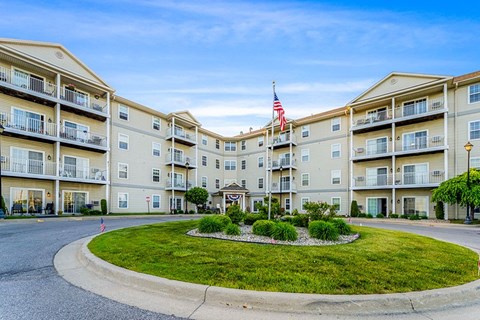 Apartment complex with a flag on the building.