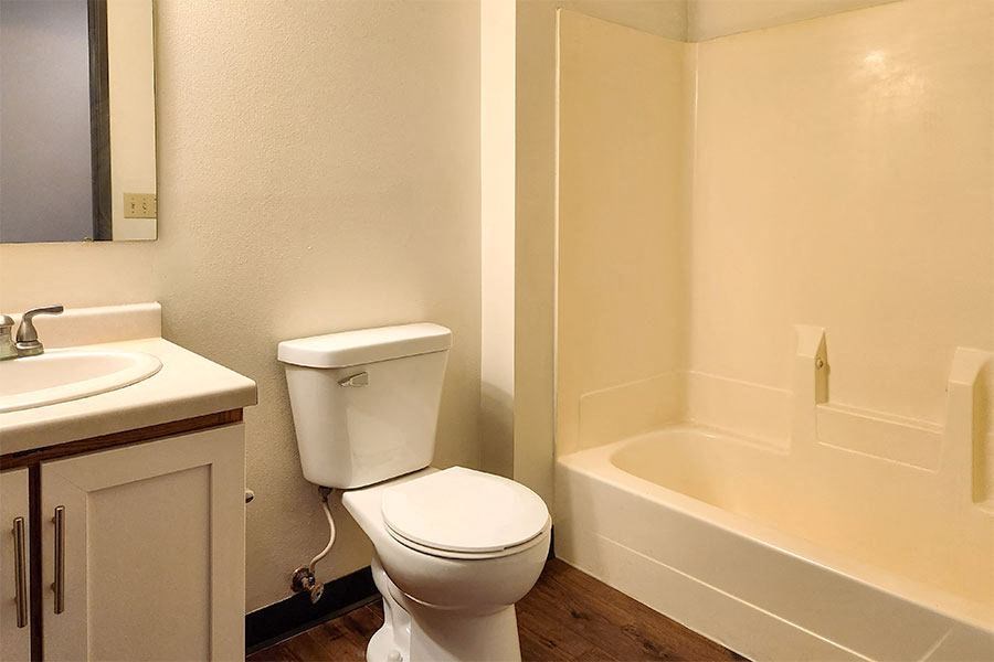 A white toilet sits next to a sink in a small bathroom.