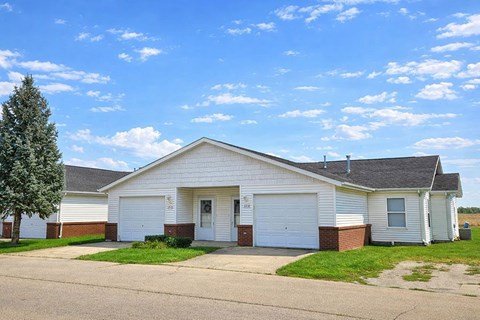 A two-car garage with a white door and a brick pillar.