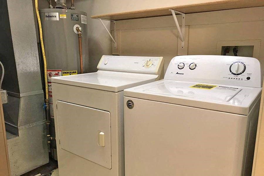 two white appliances are next to each other in a room