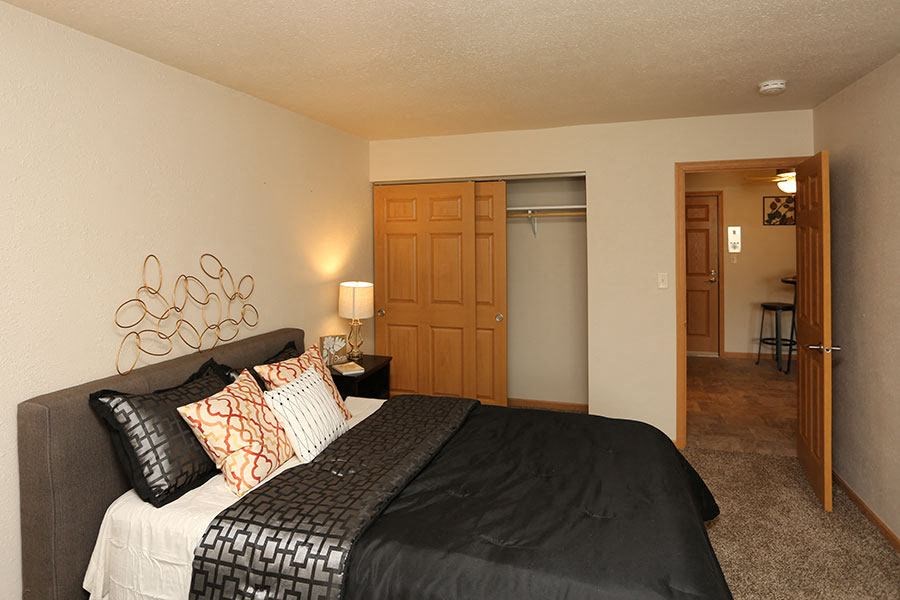 a bedroom with a bed and a door to a bathroom