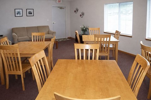A room with a table and chairs and a couch.