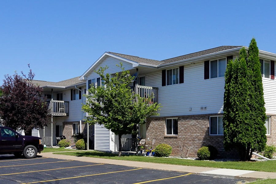 an apartment building with a truck parked in front of it