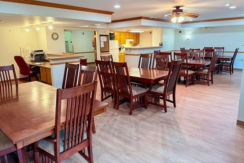 A dining room with wooden chairs and tables.
