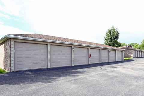 a garage with white doors and a red fire hydrant