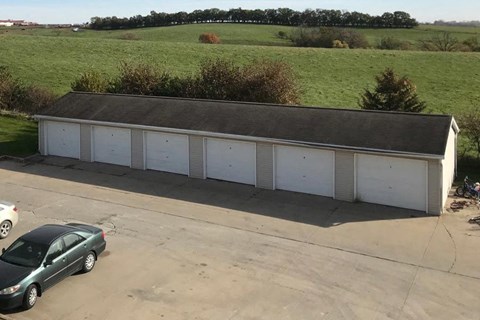a car parked in front of a white garage