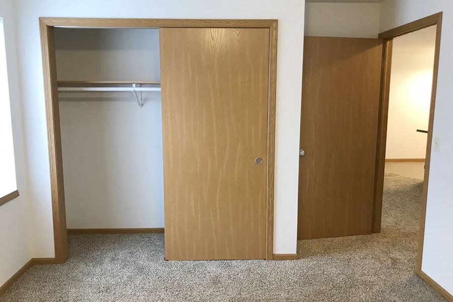 a bedroom with a closet and an open door