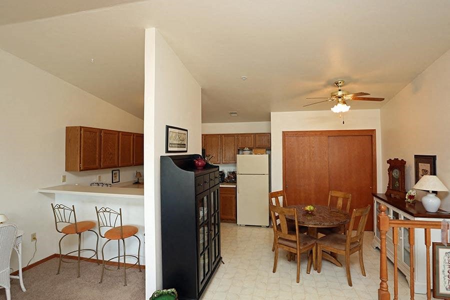 a kitchen and dining room with a table and chairs
