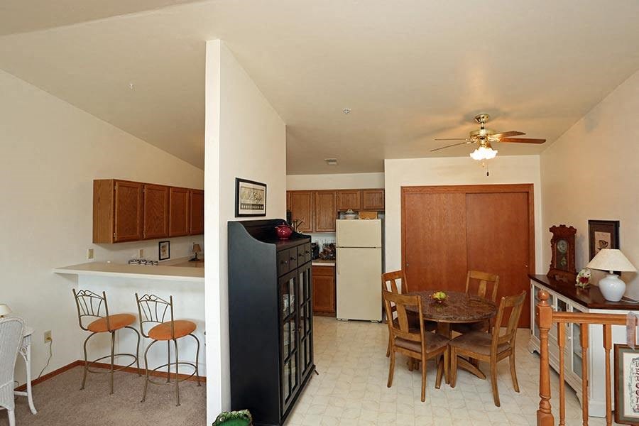 a kitchen and dining room with a table and chairs