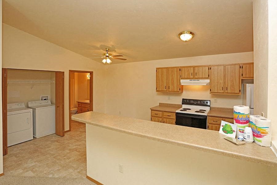 an empty kitchen with a counter top