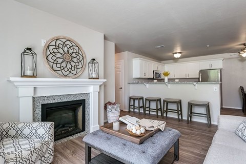 A living room with a fireplace and a coffee table.