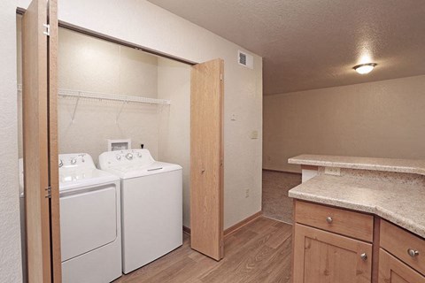 a kitchen with a washer and dryer in it